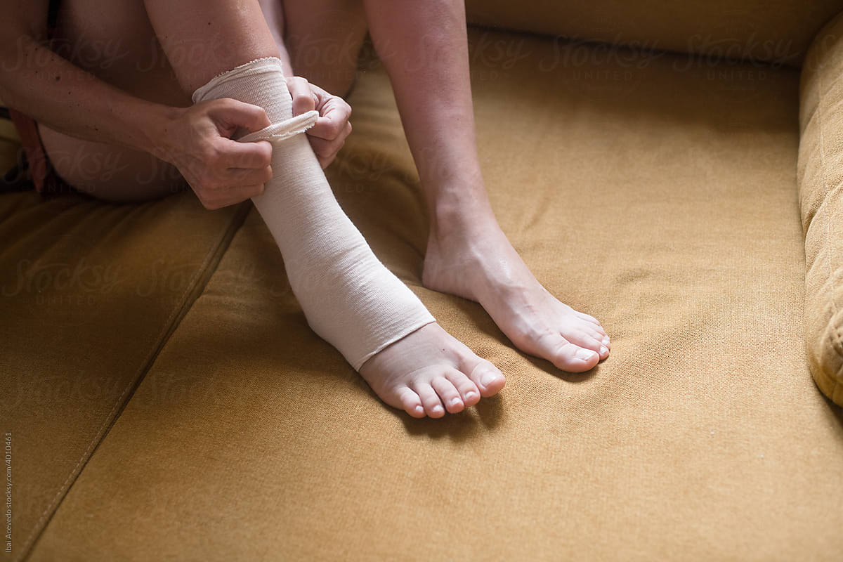 Woman taking care of her harmed ankle