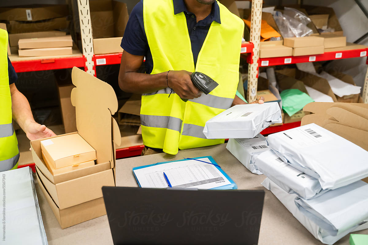 Anonymous Warehouse Worker Scanning Parcel Indoors