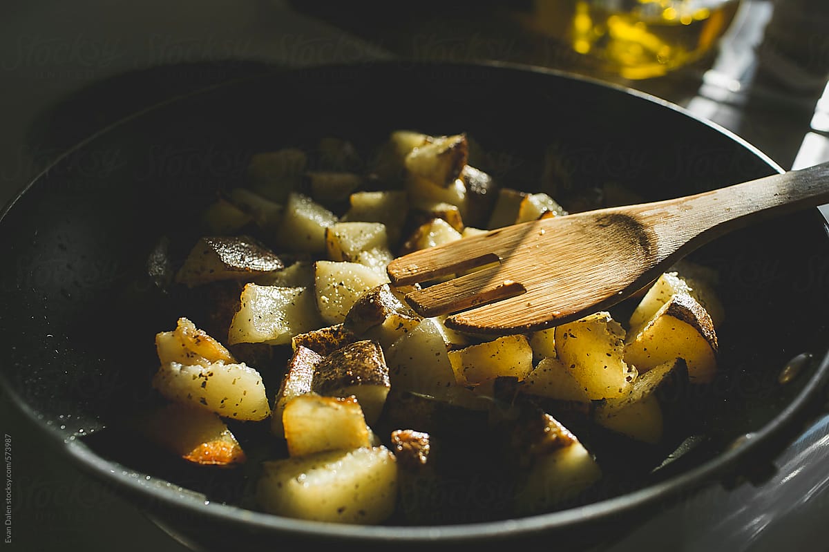 Cooking diced potatoes in a pan