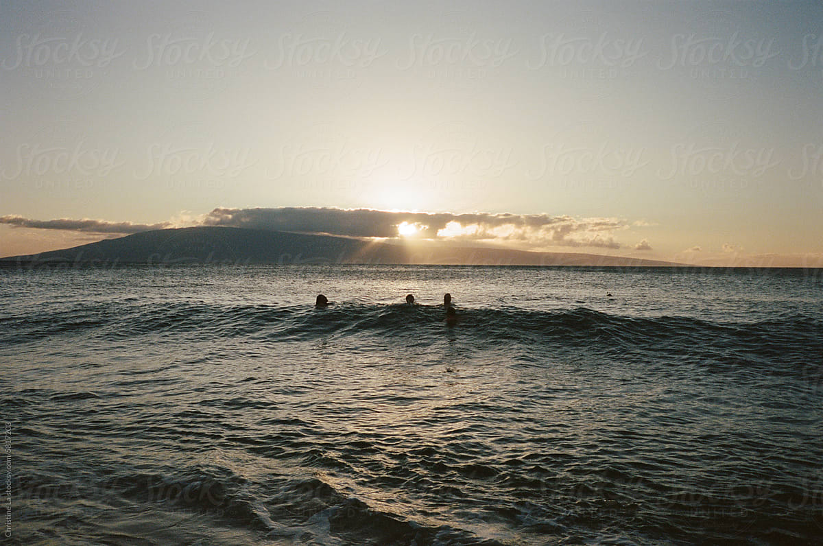 Friends body surfing in the ocean