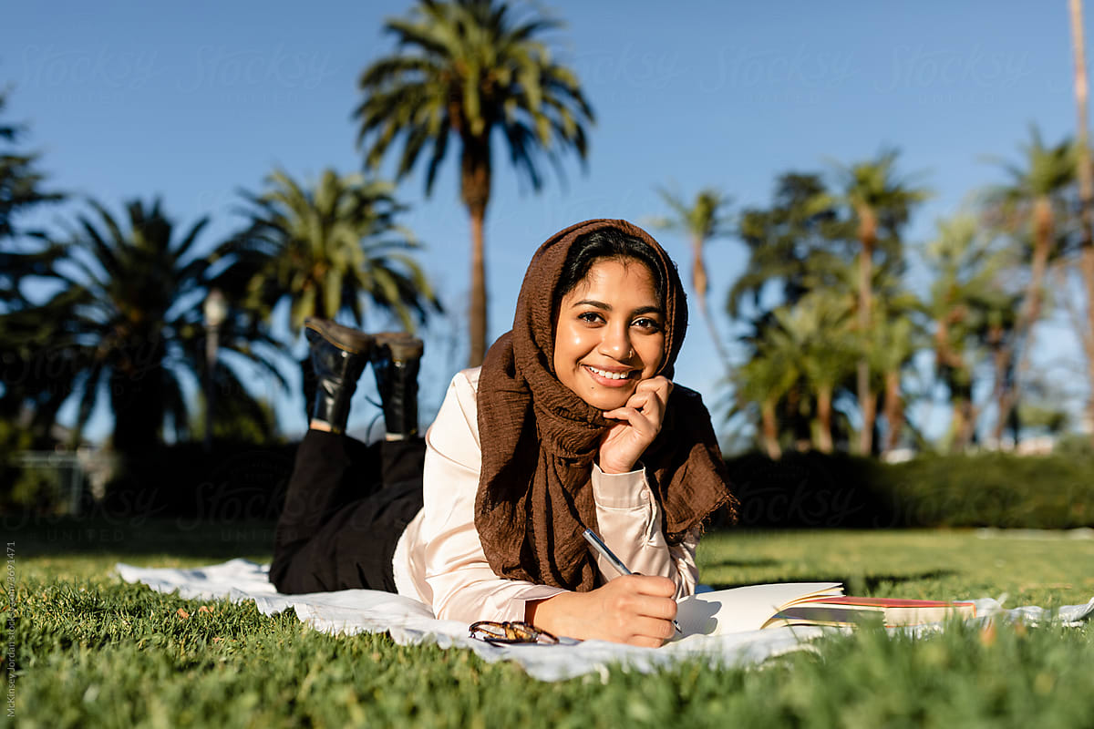 Cute Muslim Woman Writes in Park