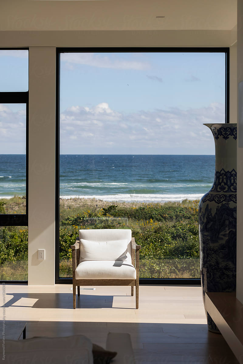 Ocean seen from inside Luxury Contemporary Home with single chair