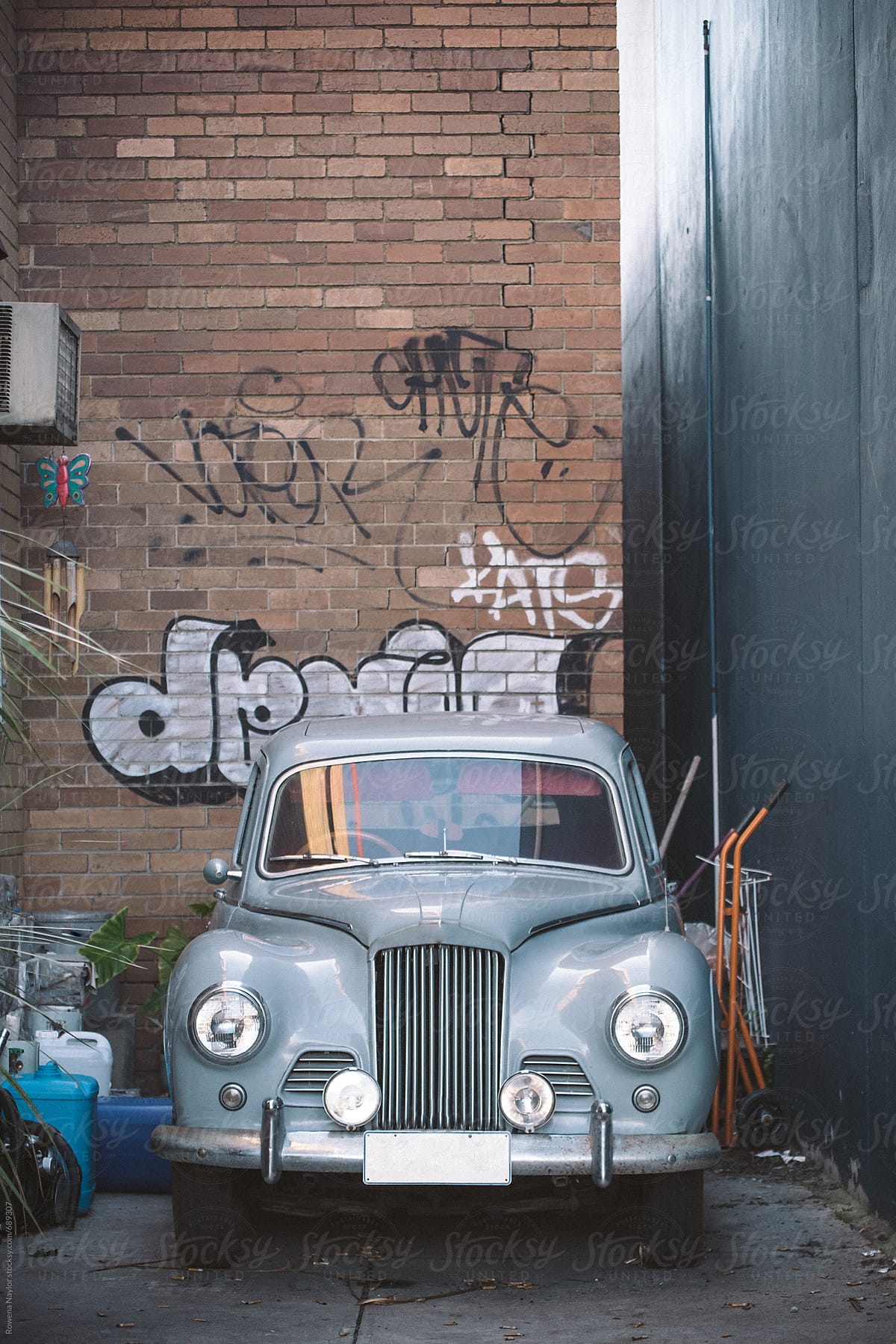 Vintage car parked in alley