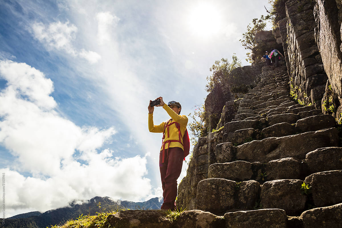 Hiker Photographing View from Top of Huayna Picchu