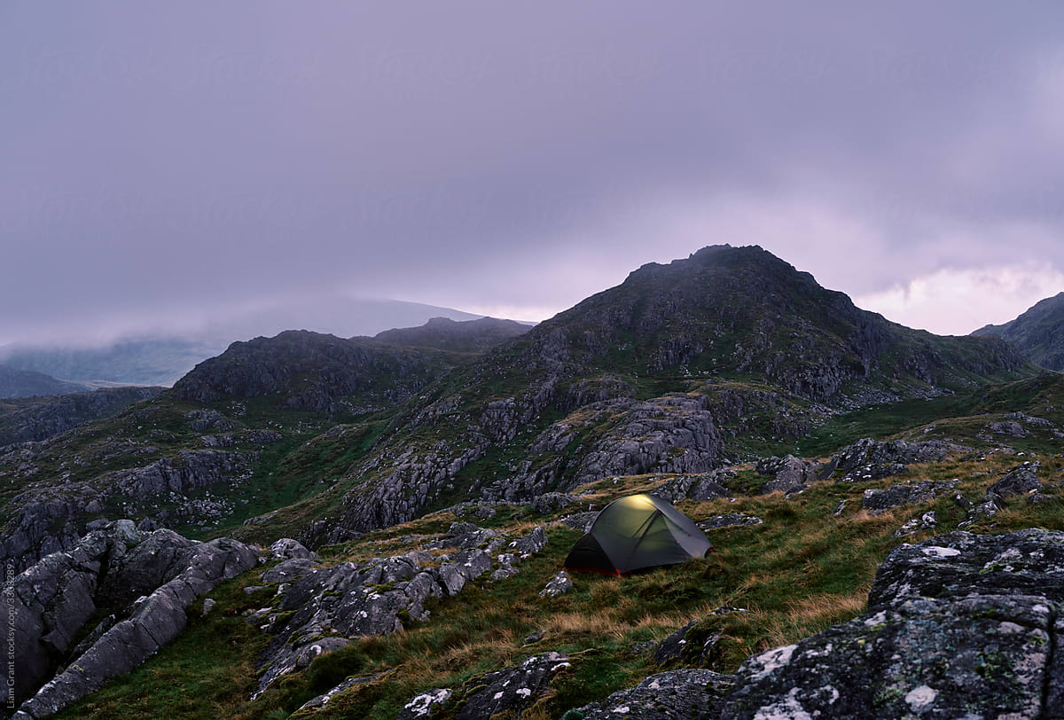 Tent pitched in the mountains at dusk. Below Bessyboot. Stonethwaite, Lake District, Cumbria, UK.