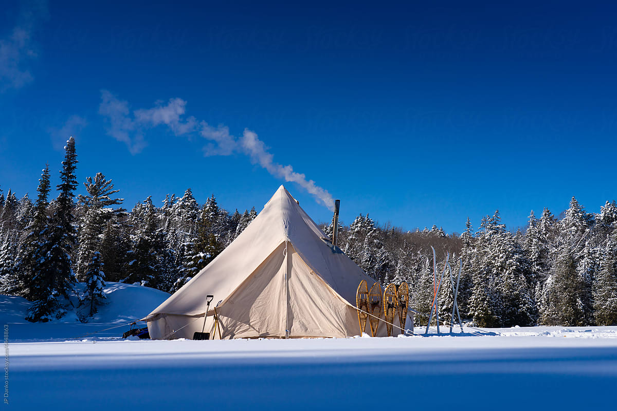 Canvas Tent with Winter Wilderness Landscape Snowshoes and Skis