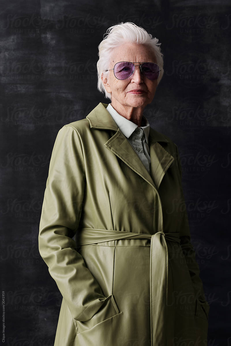 Elegant Senior Woman In Coat And Sunglasses