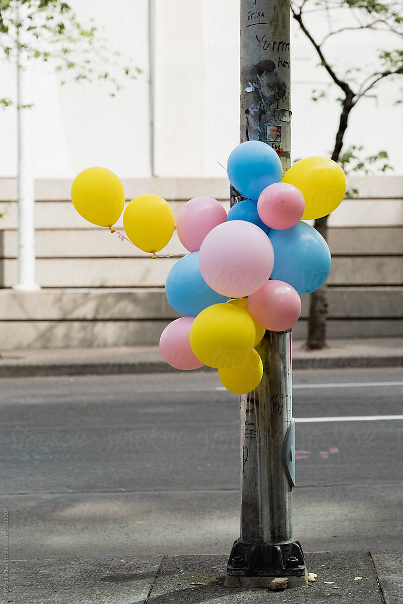 Colorful Balloons Tied Around a Lamp Post
