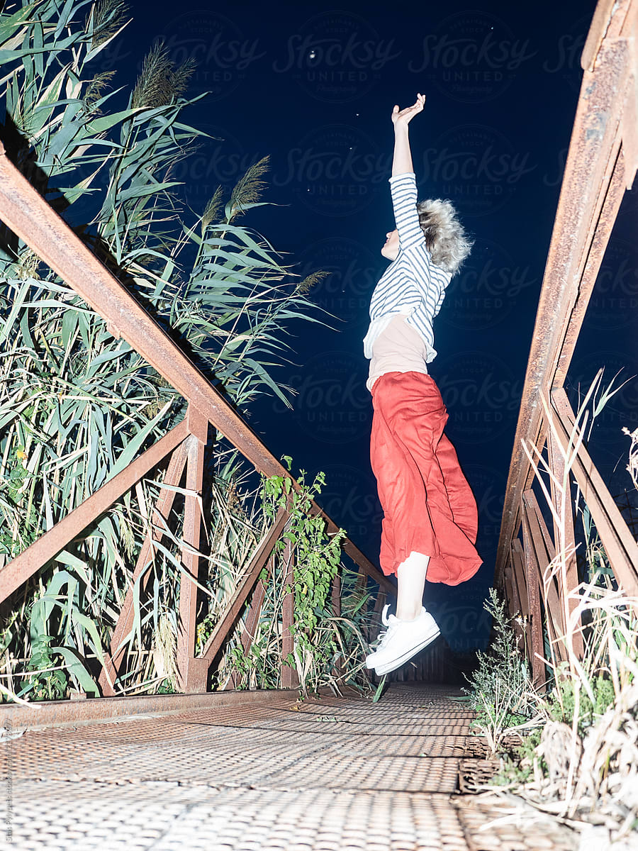The girl on the bridge reaches for the stars