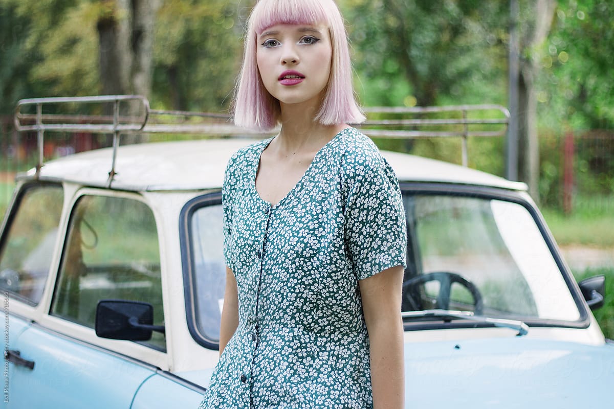 Portrait Of A Beautiful Young Woman Near Oldtimer Car by Stocksy