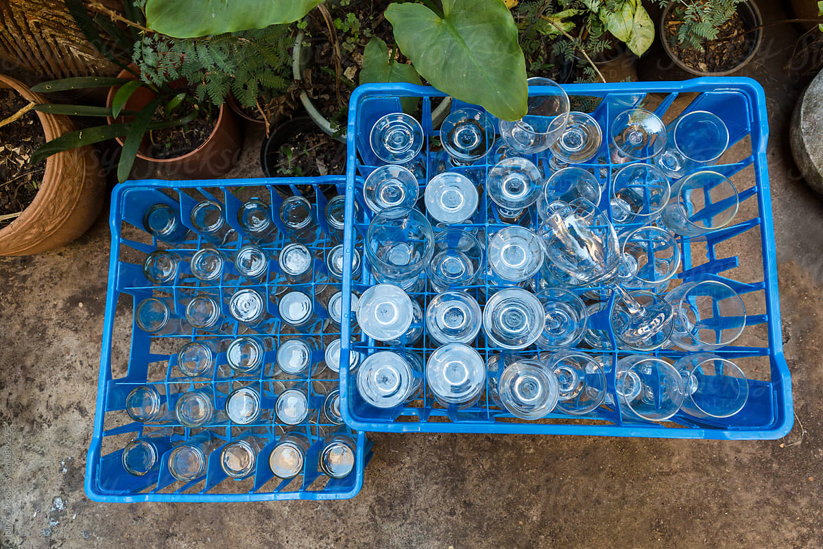 Two Blue Crates Filled with Empty Glassware