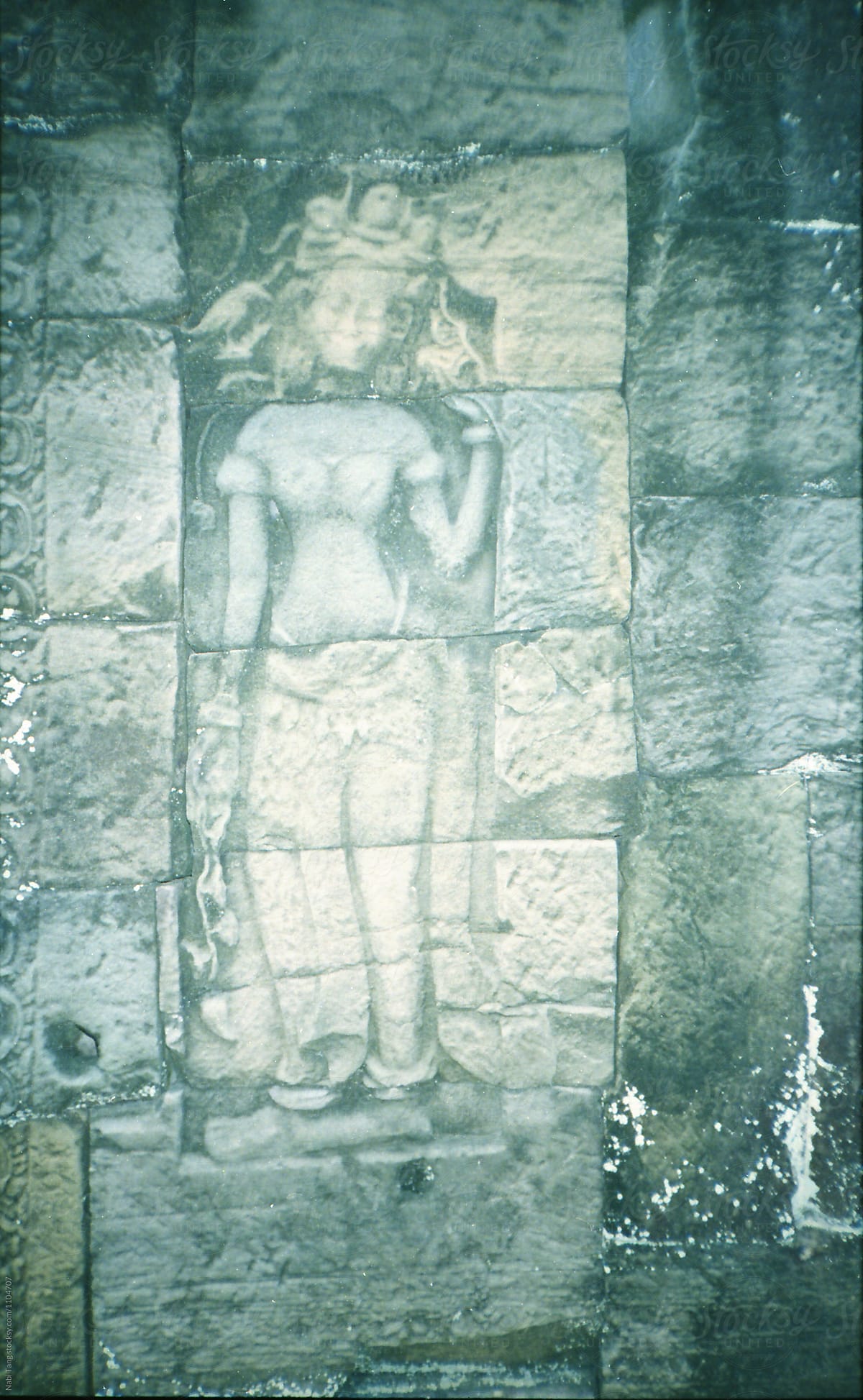 Goddess sculpture on the temple wall in Siem Reap (Cambodia)