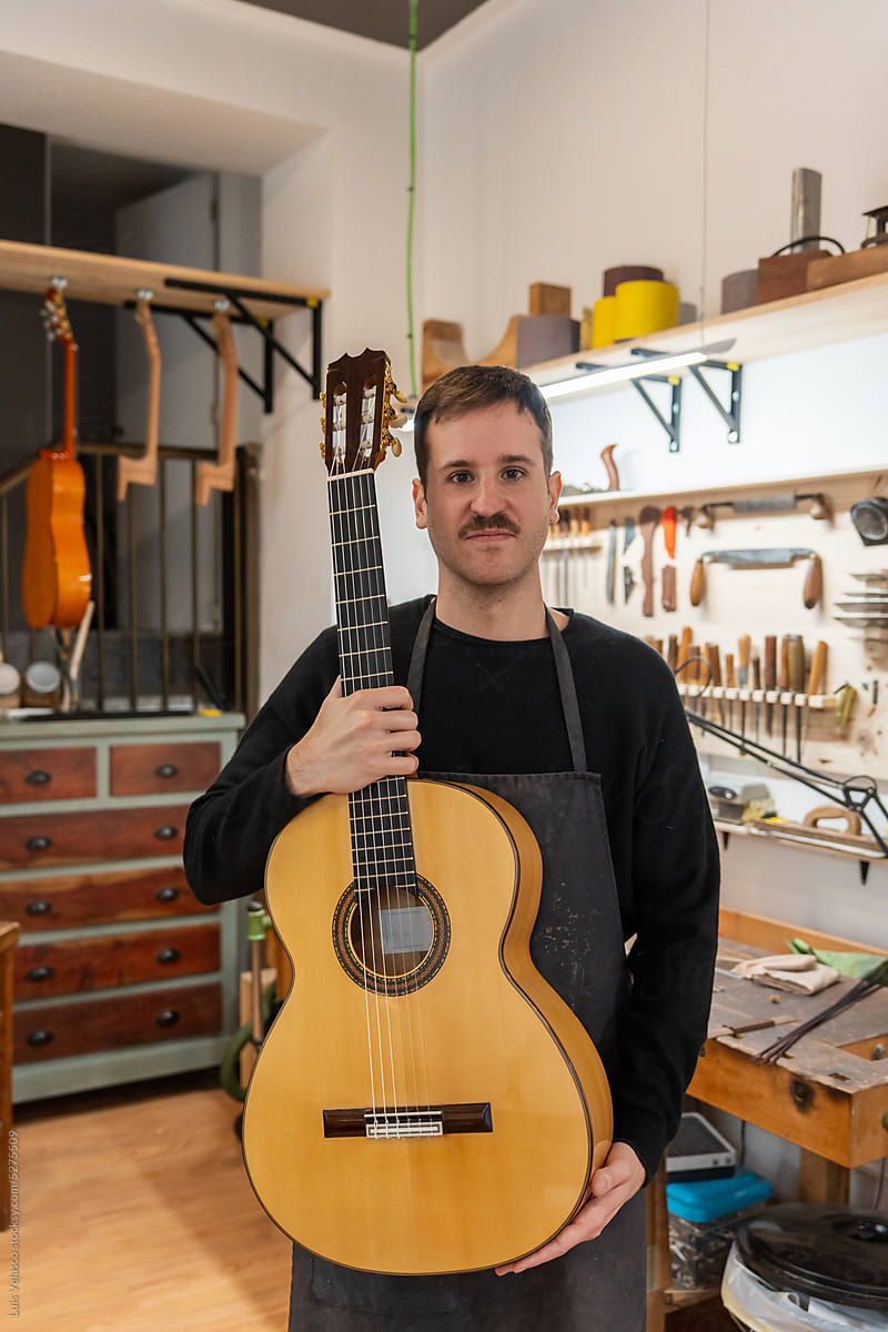 Portrait Of A Luthier, Guitar Maker In His Studio.
