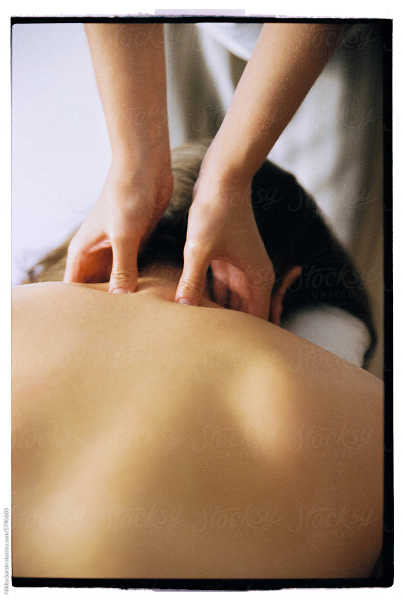 Woman receiving neck massage at beauty salon