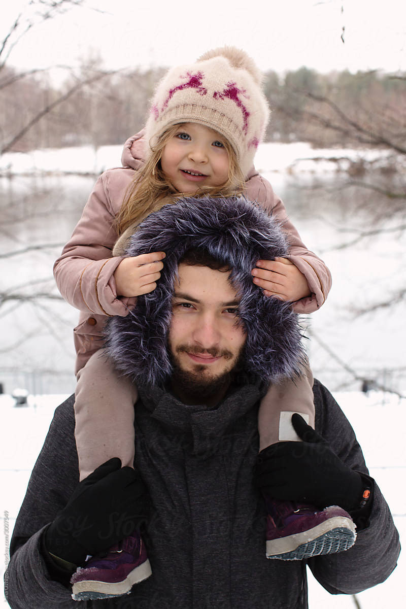 Father and little daughter in a winter park