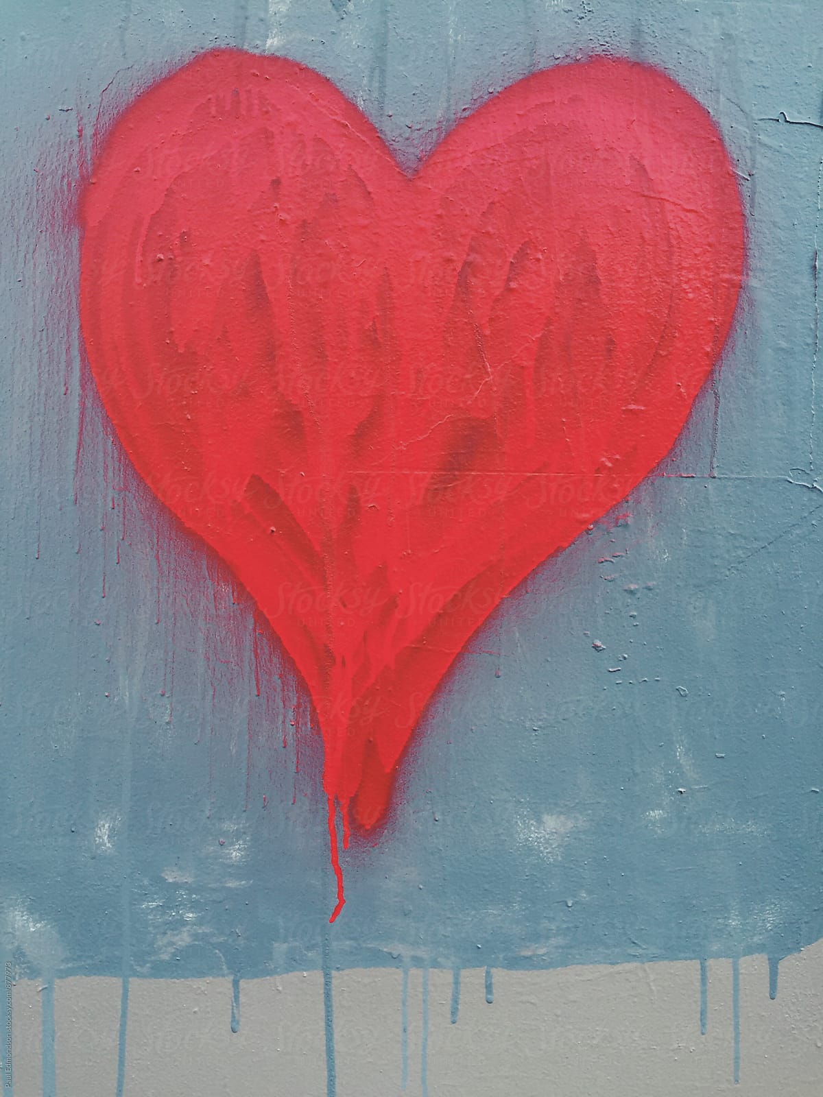 Red spray painted heart shape on wall