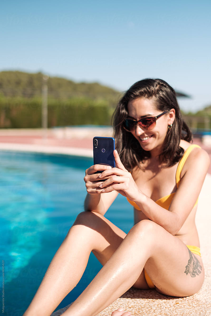 woman taking a selfie in pool