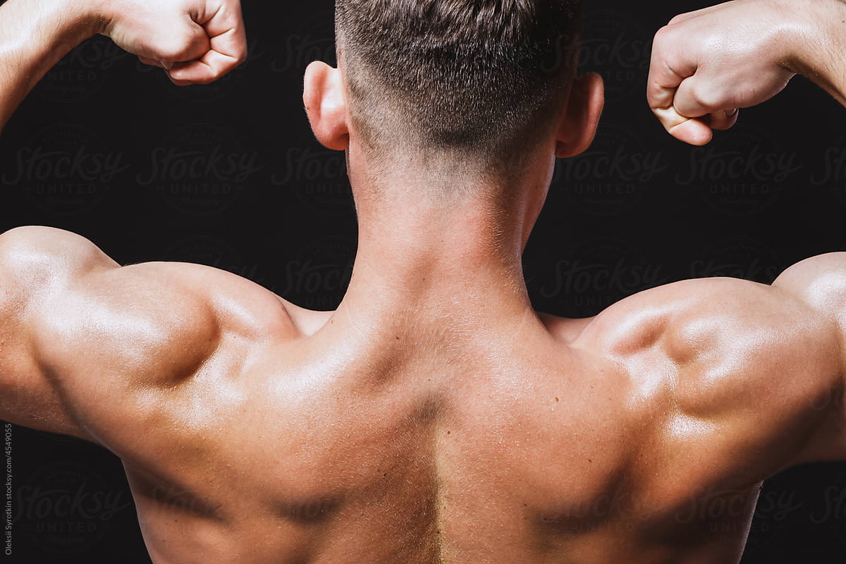 Athletic back of muscular male trainer