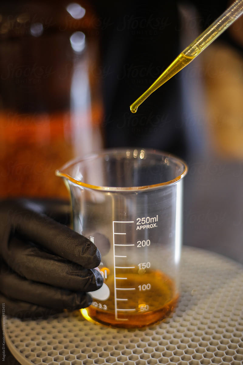 Anonymous Scientist Measuring Liquid in Beaker
