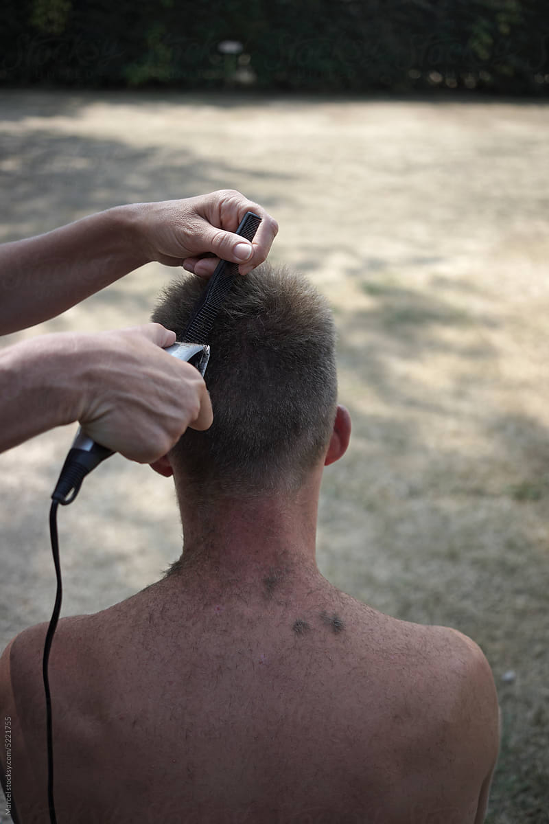 Trimming the hair of a young man