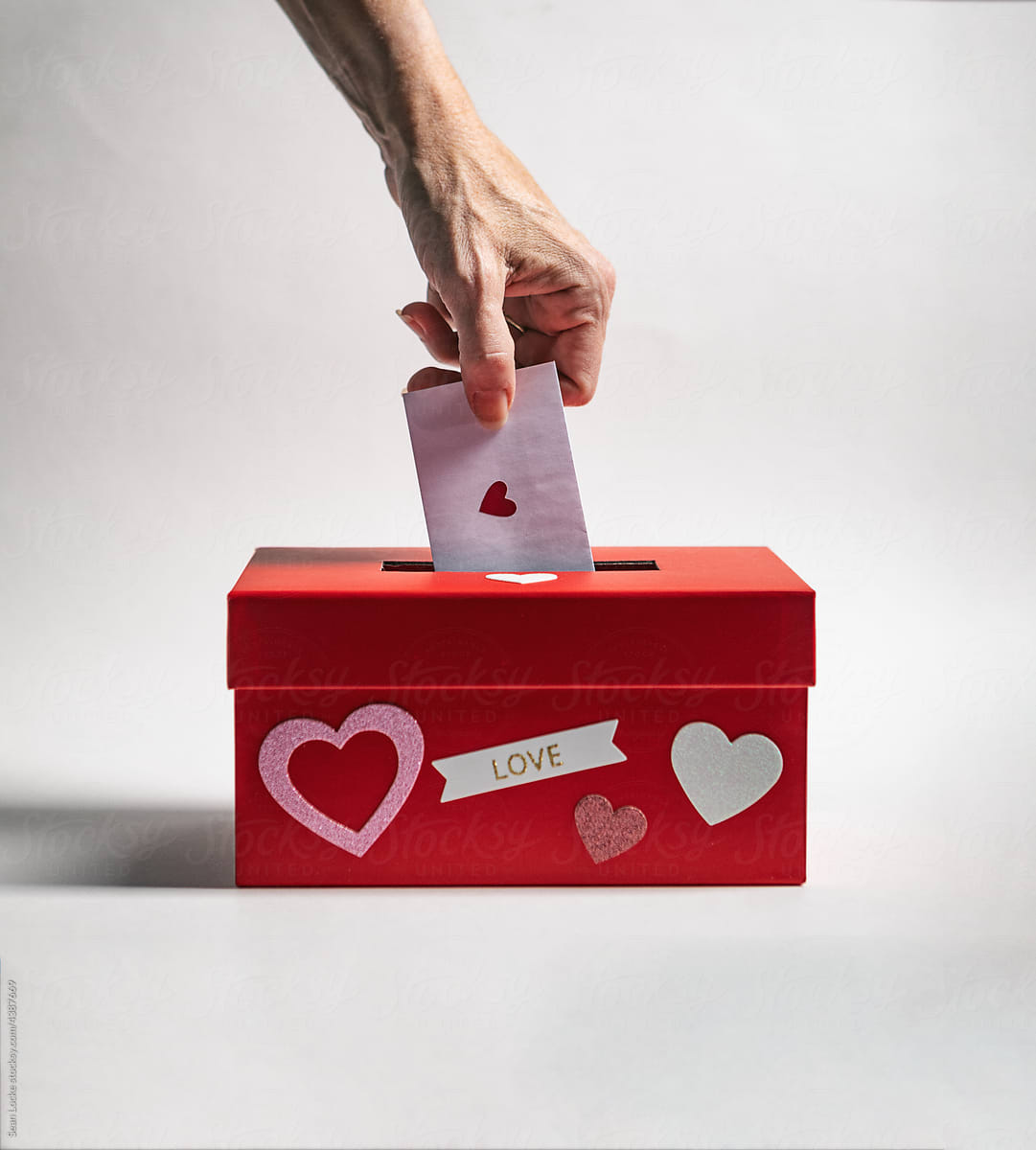 Woman Putting Valentine In Heart Box