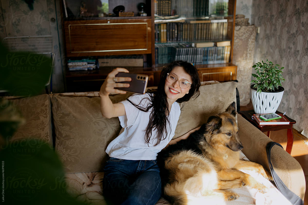 Girl taking selfie with her dog