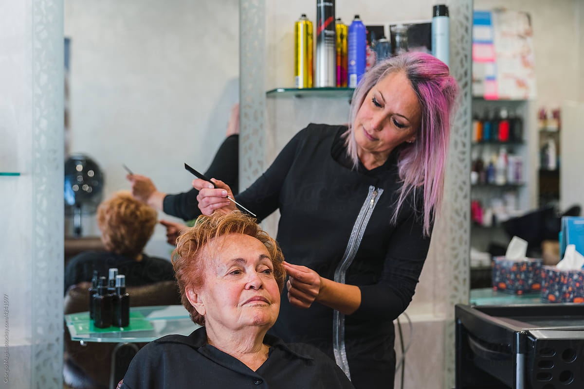 Professional Hairdresser Combing a Senior Client