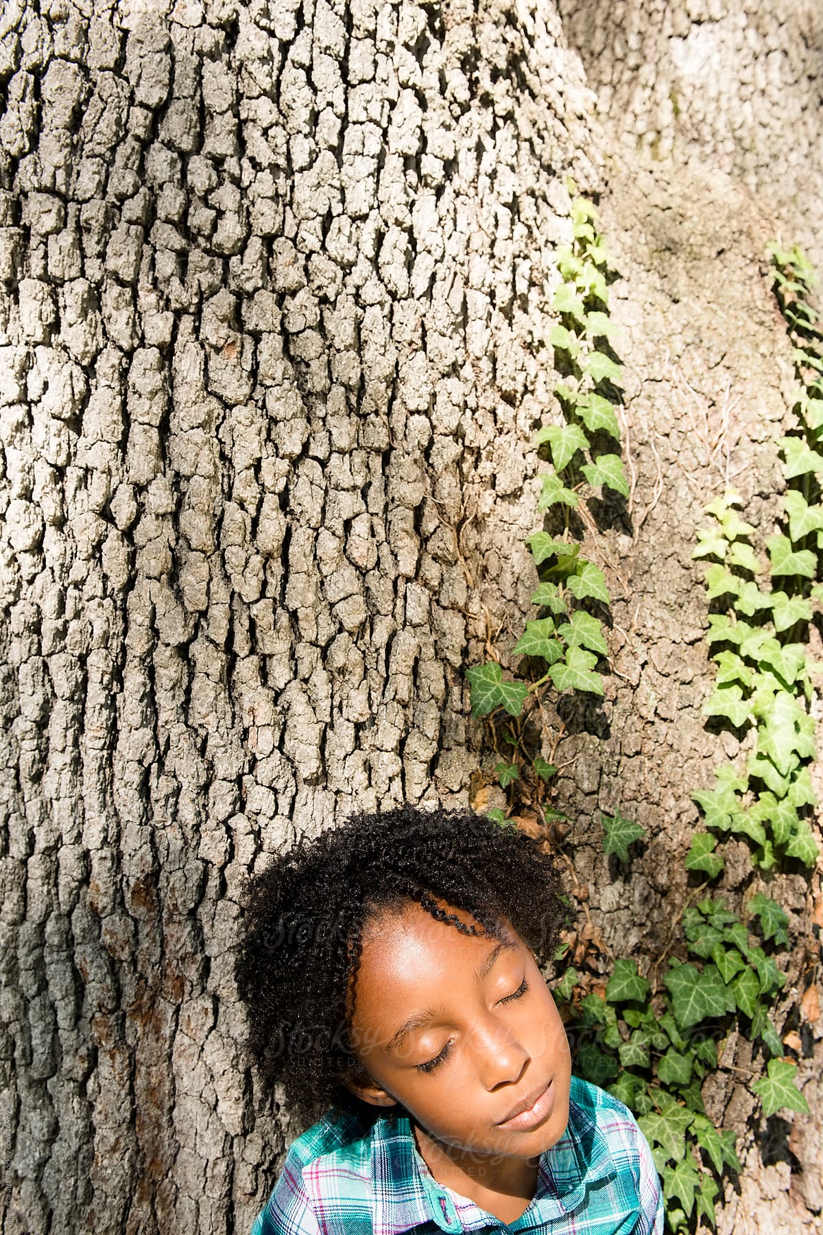 Girl resting on tree