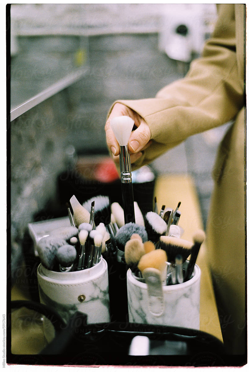 Makeup artist taking brush