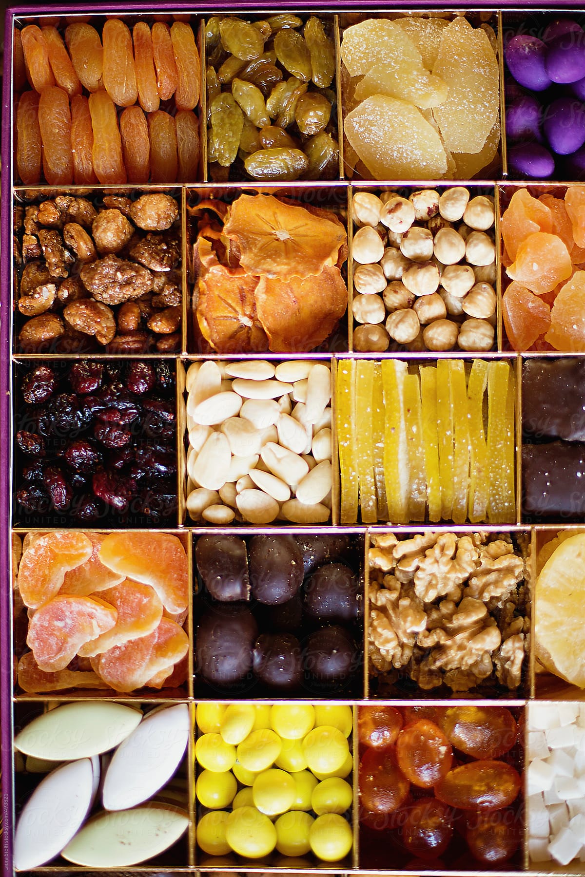 Overhead shot of mixed dried fruits, sweets, nuts and chocolates box