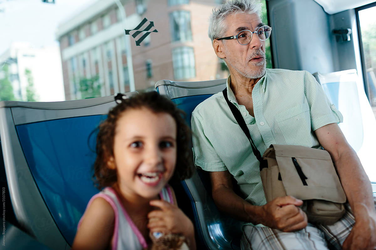 Grandfather and granddaughter on the bus