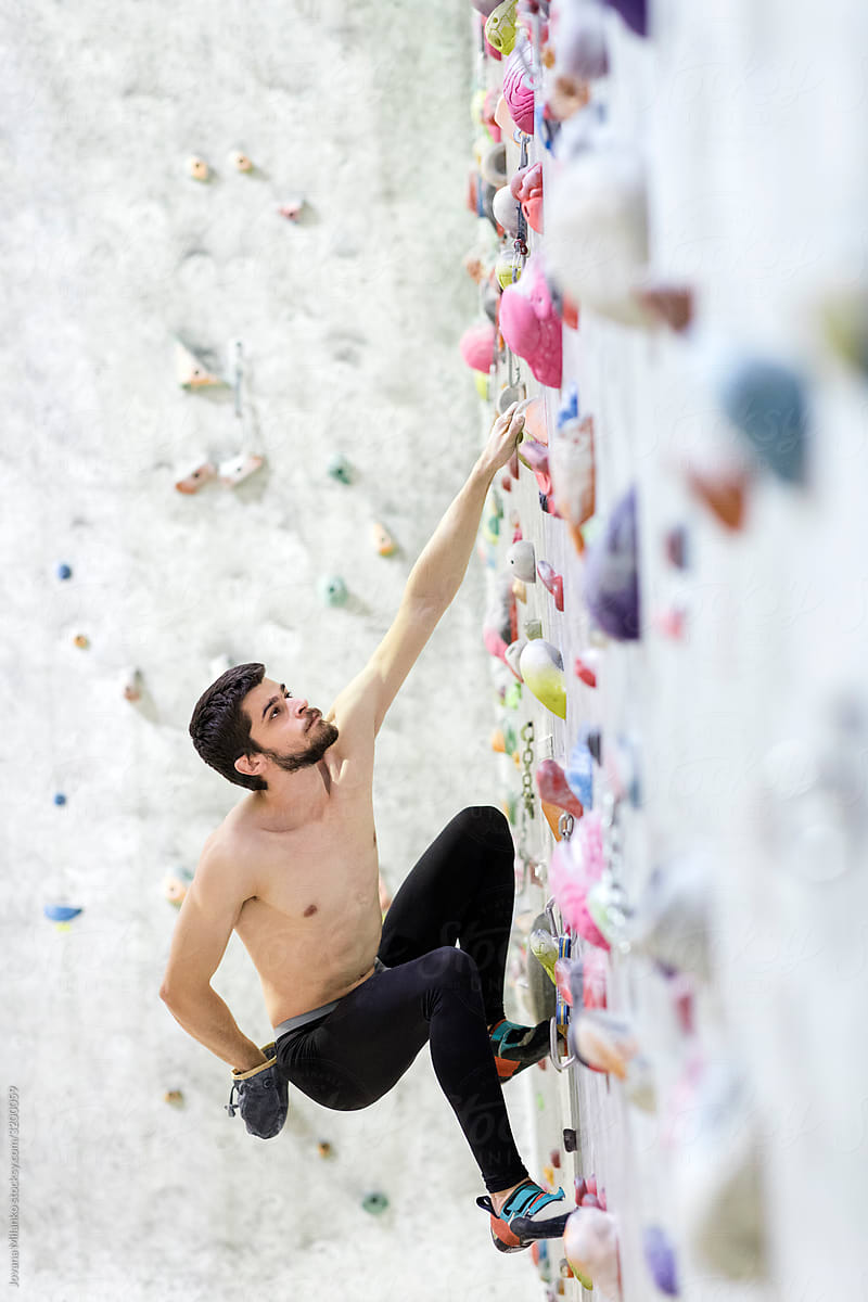 Free climber bouldering in the climbing gym