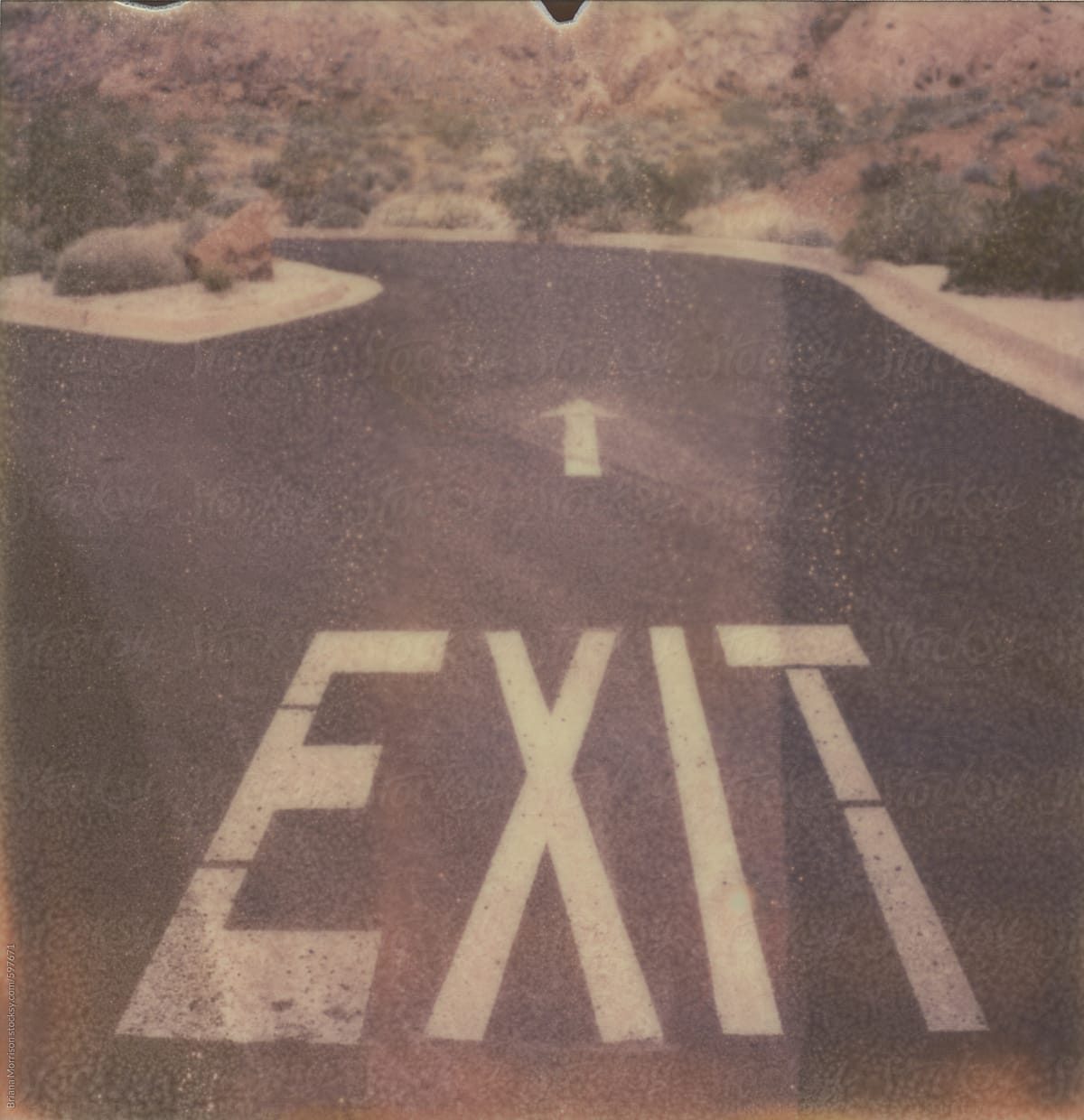 Exit Sign and Arrow Painted on Pavement in the Desert