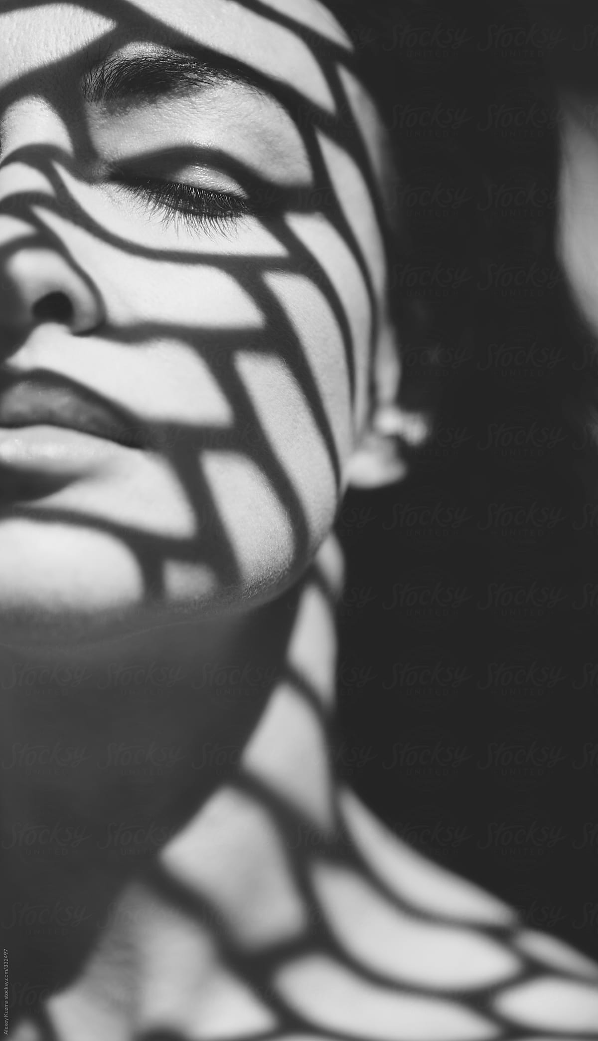 beautiful woman with a geometric patterned shadow on her face