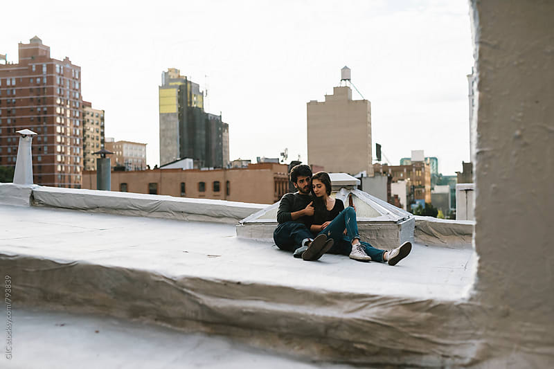 Young couple having fun on a rooftop in the city