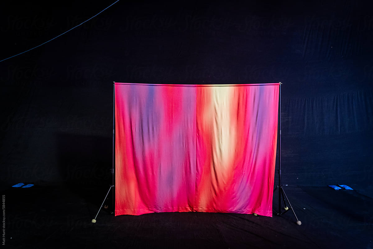A colorful tie-dye backdrop beind the scenes on set of a production