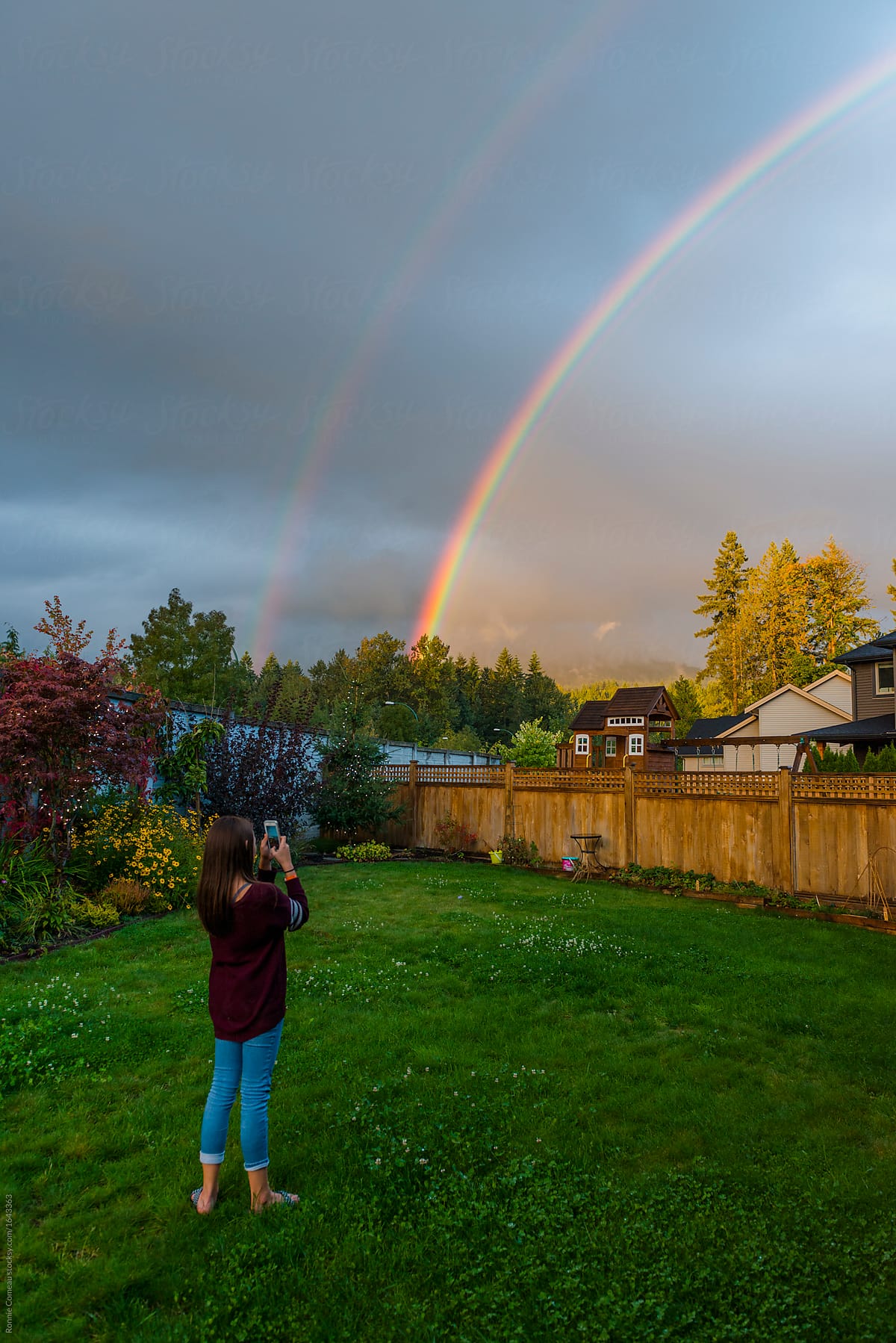 Girl Photographing Rainbow in the Backyard