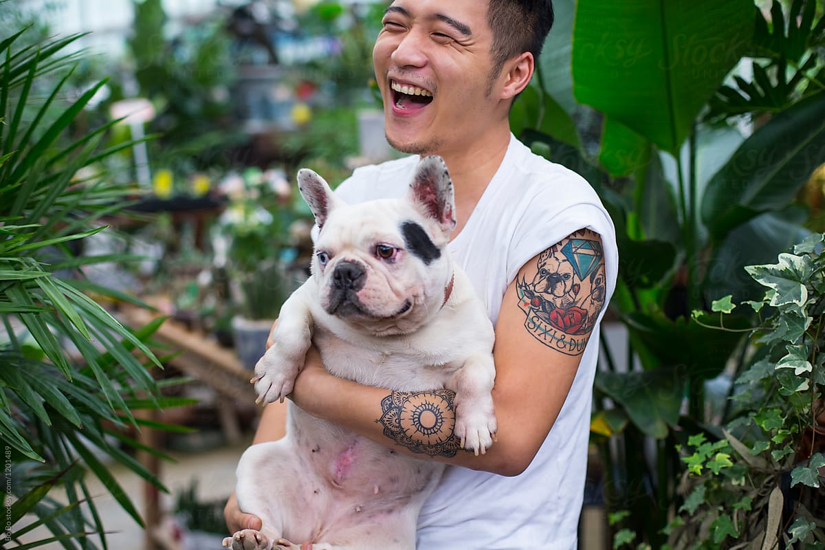 One Young Asian Man Holding his Dog