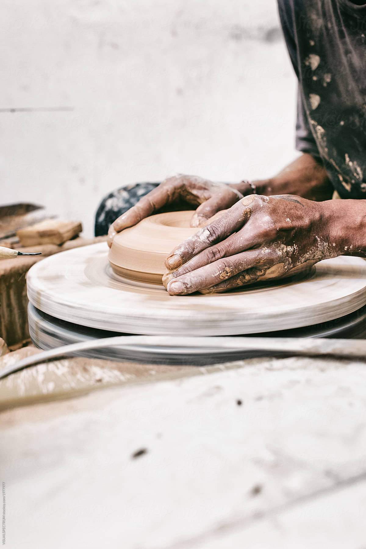 Ceramics - Close Up of Artisan Potter Making Small Vase on Flywheel