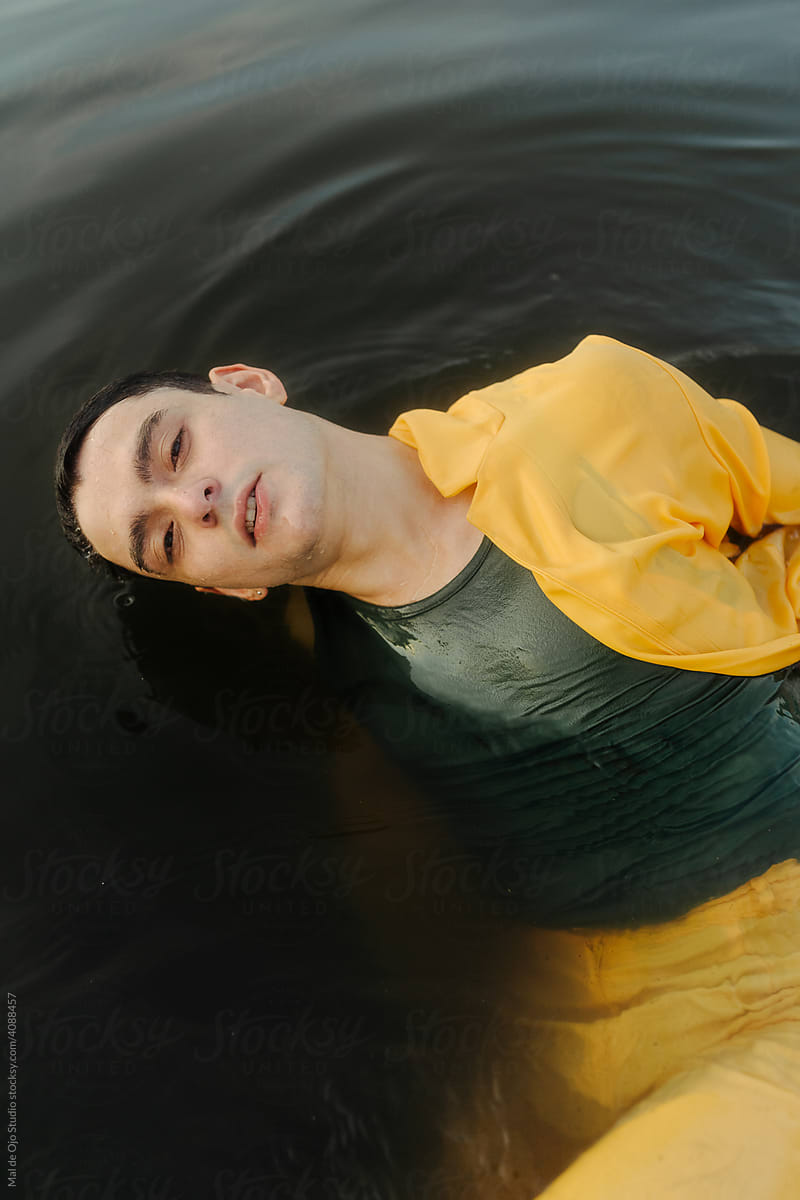 Young man floating in lake