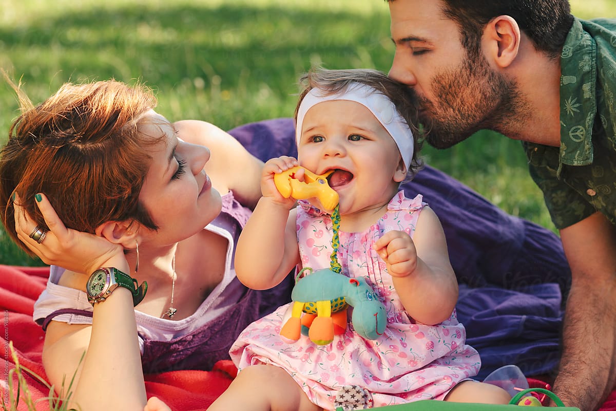 Mother, father and baby as a happy family in the park