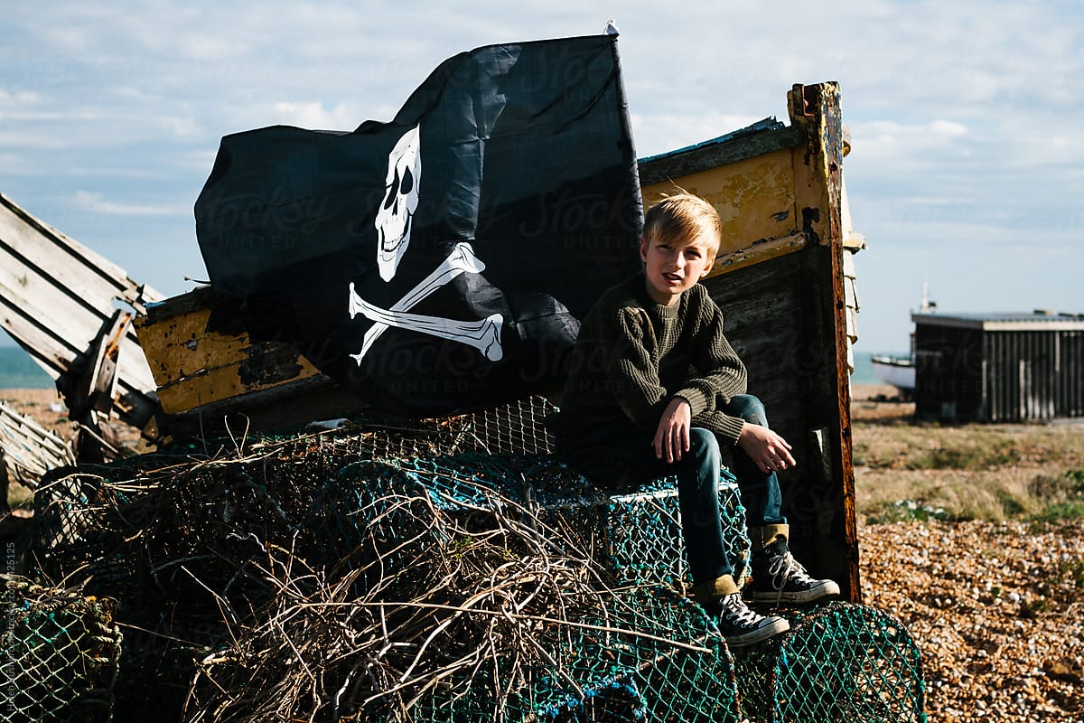 Boy, boat, pirate flag...... and all around, dereliction.