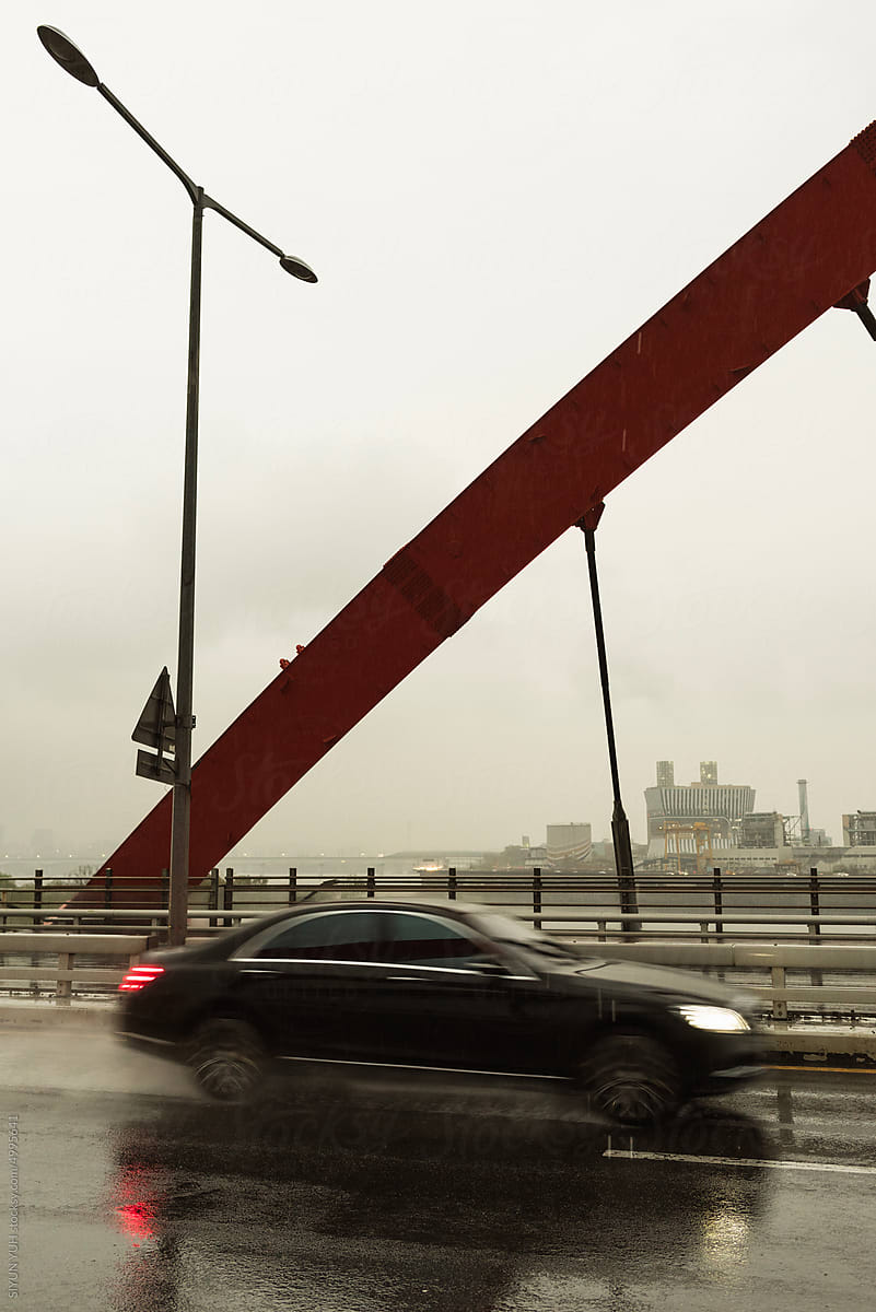 Car passing on the bridge at rainy day