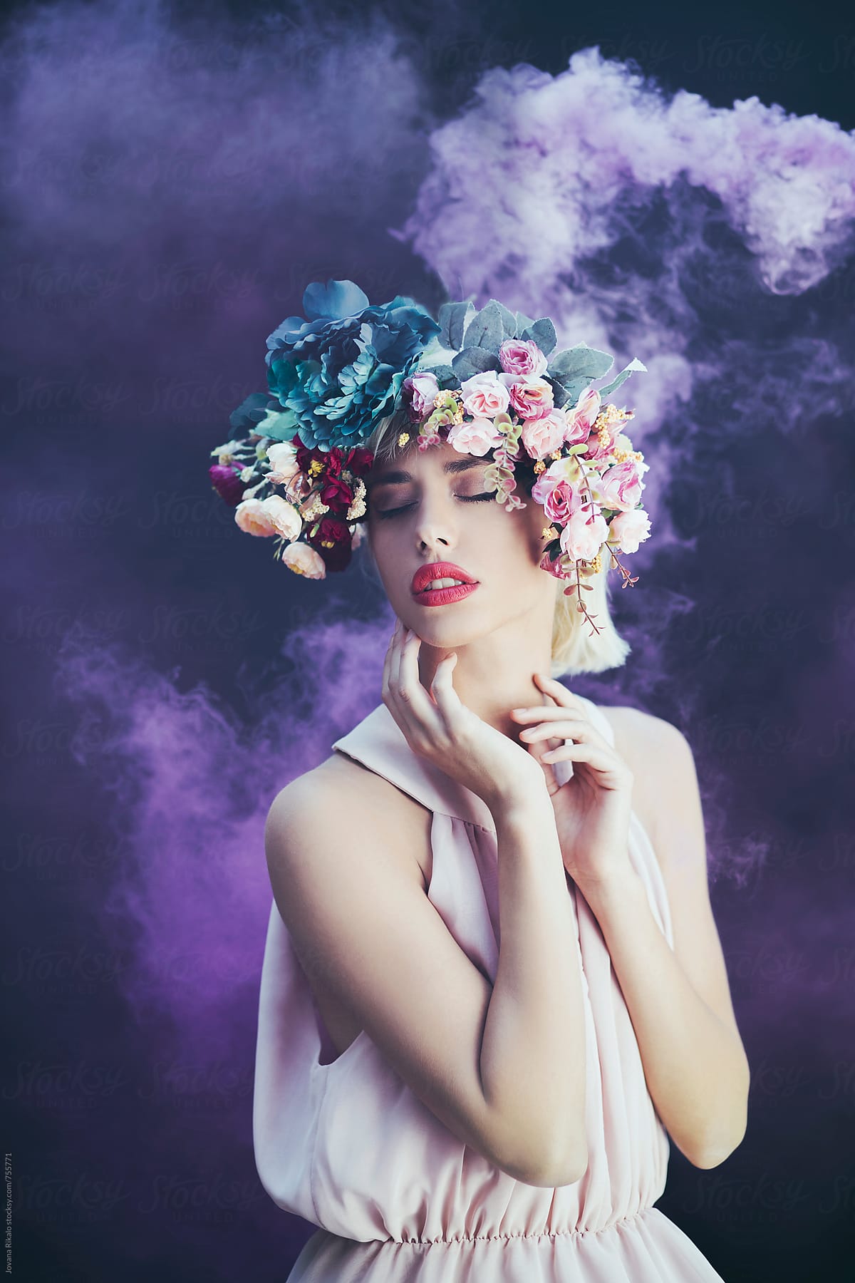 Artistic portrait of a young woman with smoke bomb