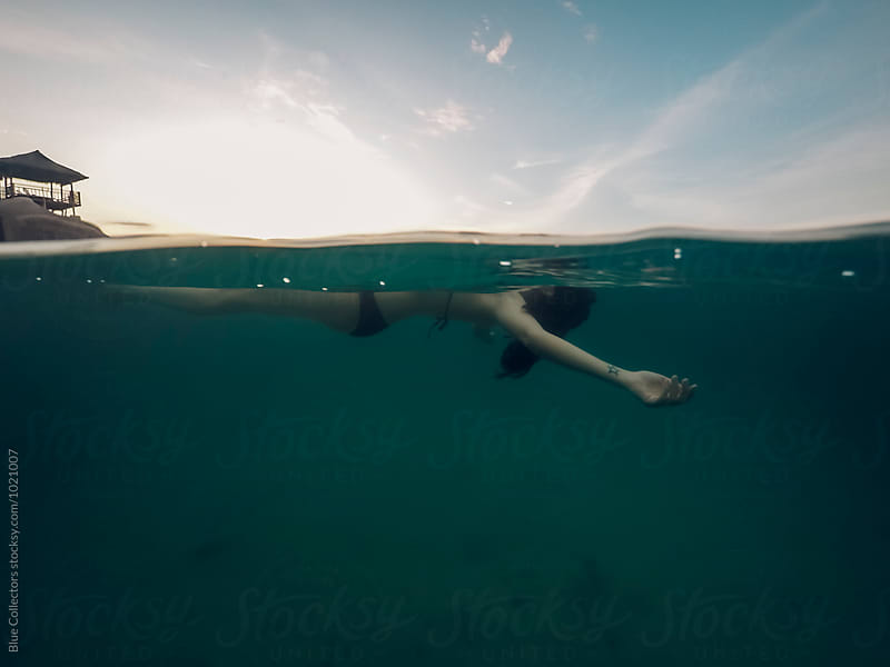 underwater view of a woman floating in the water