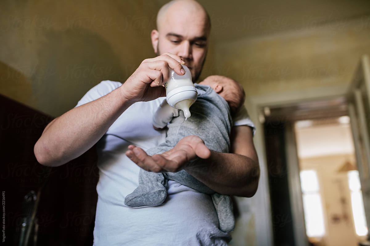 Father testing milk Temperature