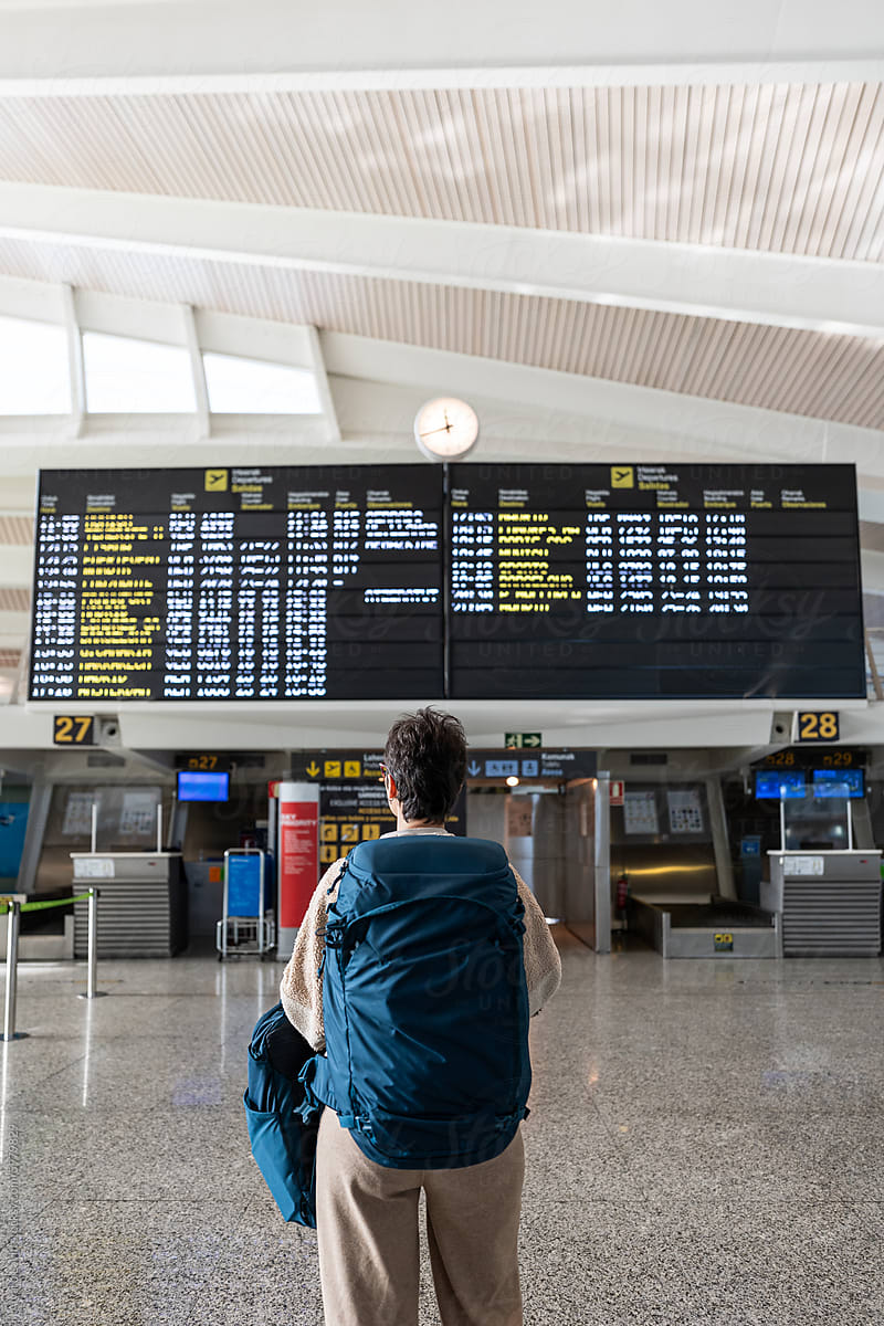 Lone traveler checking flight schedule.