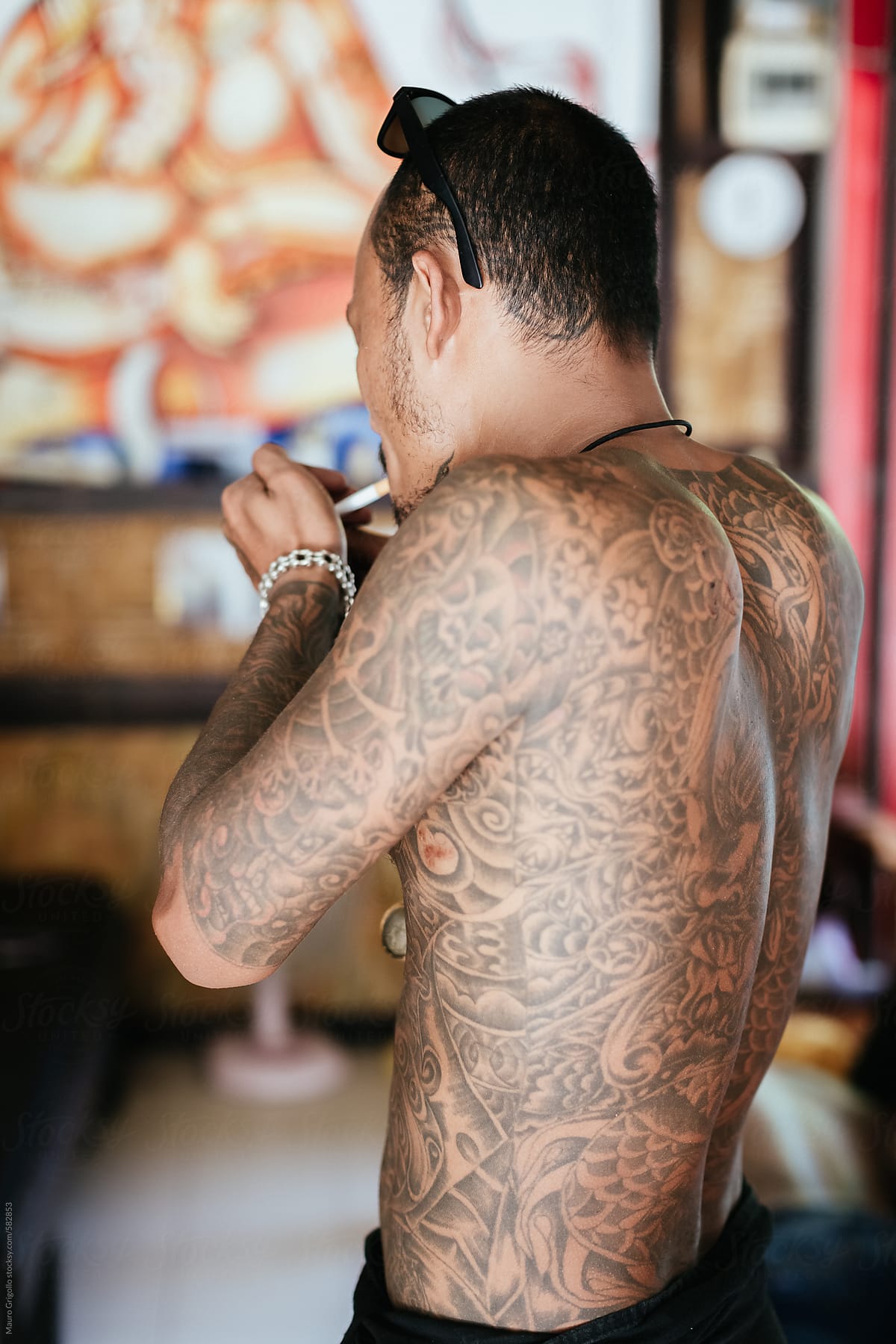 Thai Tattoo Artist Smoking A Cigarette During A Break