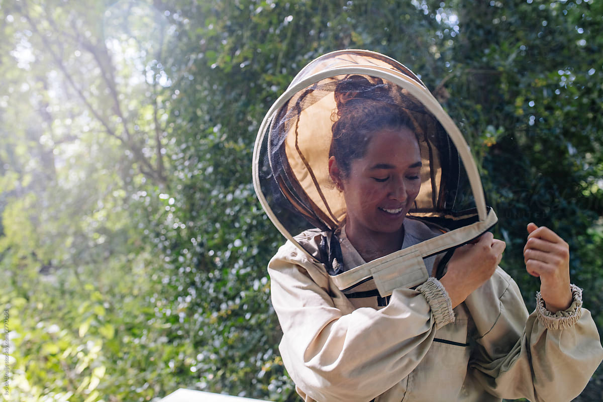 Female beekeeper putting on her bee suit. Getting ready to work
