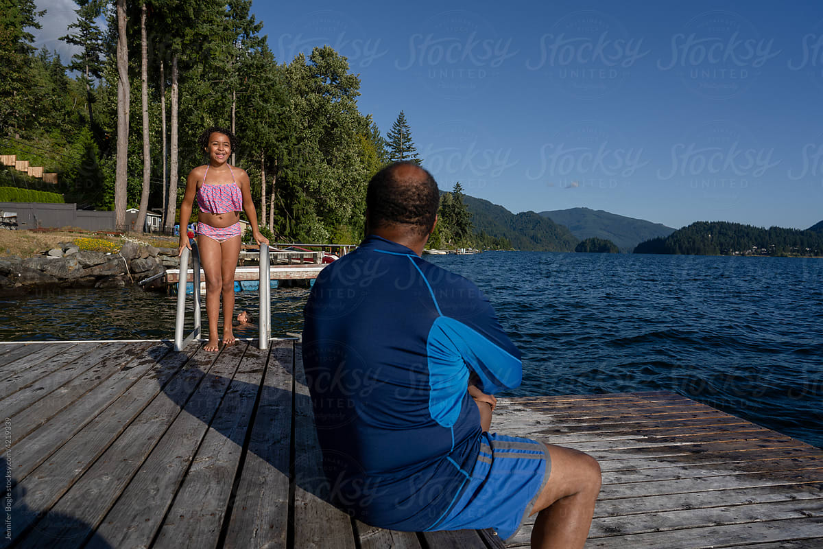 Teen Girl Laying On A Dock In Her Bikini by Stocksy Contributor